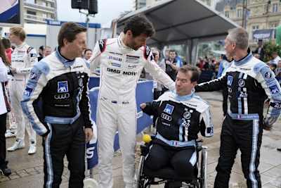 Frédéric Sausset (Mitte rechts) mit seinen Teamkollegen und Porsche-Pilot Mark Webber
