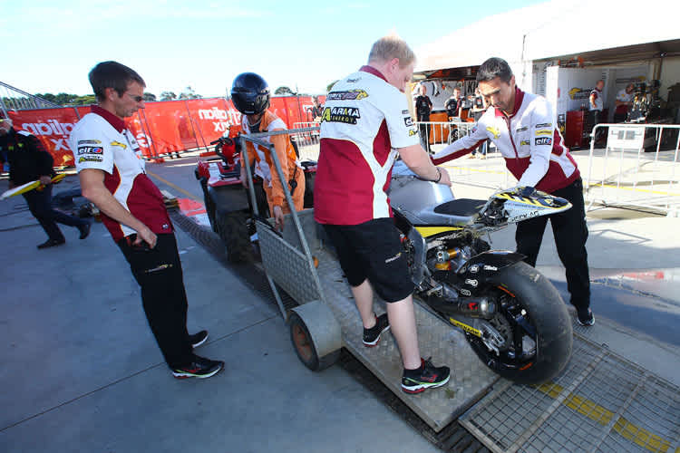 Wie gelähmt müssen die MarcVDS-Teammitglieder die Sturz-Kalex von Scott Redding in Empfang nehmen