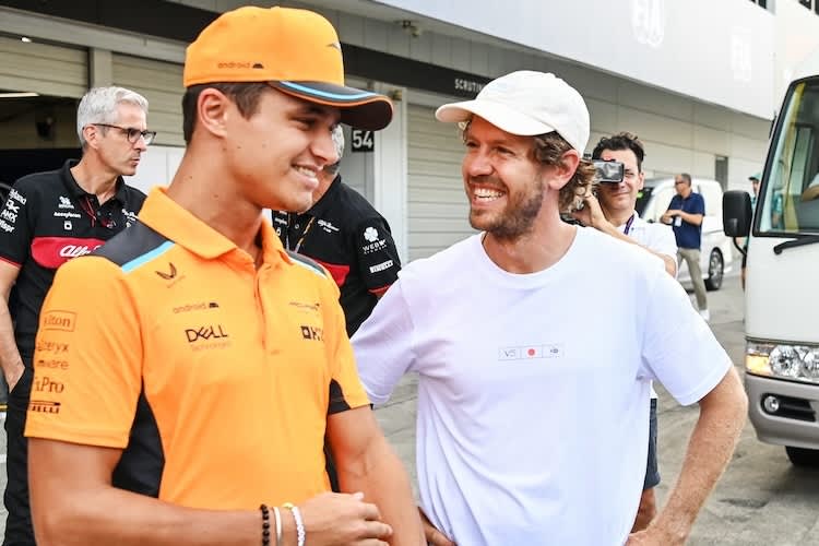 Lando Norris und Sebastian Vettel 2023 in Japan. Vettel besuchte das Rennen und installierte Bienenstöcke am Rand der Rennstrecke
